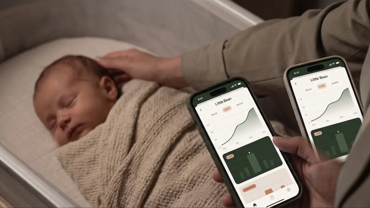 Parents comparing sleep charts in the Little Bean app beside their newborn's bassinet